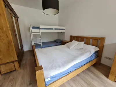a bedroom with a bunk bed with a ladder at Pirin Golf Apartment HOME with private garden in Bansko