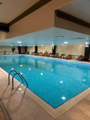 a large swimming pool in a hotel room at Grand Monastery Pamporovo Apartment for rent in Pamporovo