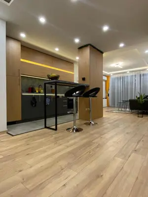a living room with a bar with stools in it at DV13 Luxury Suite Sofia Center in Sofia