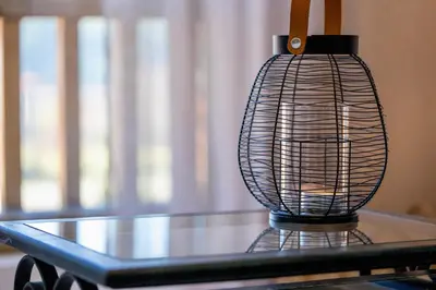 a black bird cage sitting on top of a table at Studio 9, St John Park in Bansko