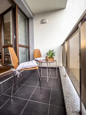 a balcony with two chairs and a table on a floor at The Boulevard Luxury Apartment in Sofia