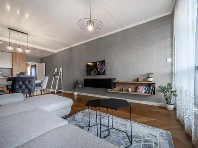 a living room with a couch and a table at The Boulevard Luxury Apartment in Sofia