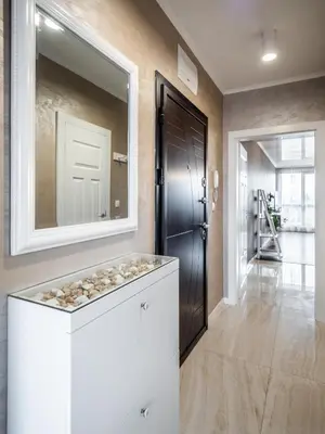 a home hallway with a large mirror and a door at The Boulevard Luxury Apartment in Sofia