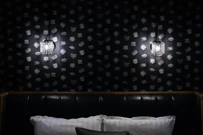 a bedroom with a black wall with lights on it at HIDDEN BANK: DIAMONDS in Plovdiv