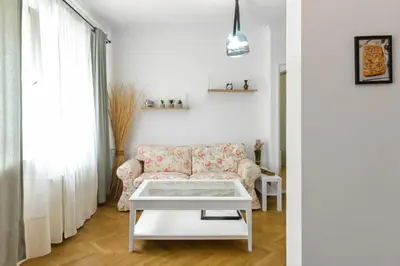 a living room with a couch and a table at Floral Studio Retreat in Sofia City Center by Flat Mаnager in Sofia
