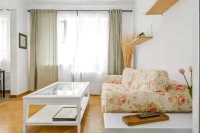 a living room with a couch and a table at Floral Studio Retreat in Sofia City Center by Flat Mаnager in Sofia