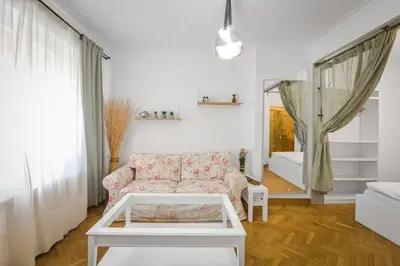 a living room with a couch and a table at Floral Studio Retreat in Sofia City Center by Flat Mаnager in Sofia