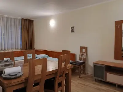 a room with a table and a dining room at Kolimechkov Apartments Borovets in Borovets