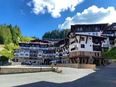 a large building in the middle of a street at GrandView Apartment Grand Monastery in Pamporovo