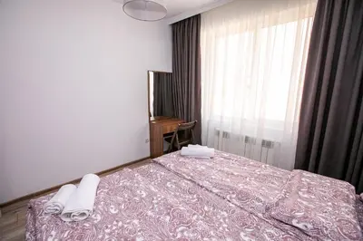 a bedroom with a bed with two towels on it at Paradise Apartment in Sandanski