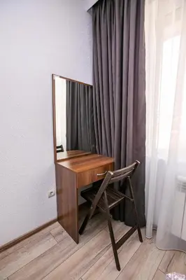 a desk with a mirror and a chair in a room at Paradise Apartment in Sandanski