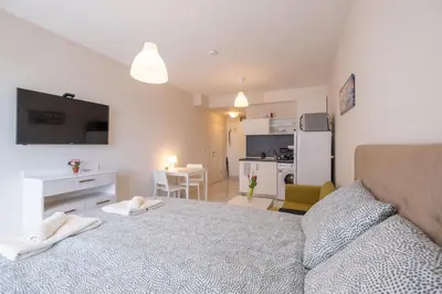 a bedroom with a bed with two white towels on it at Sunny Dream Apartments in Sofia