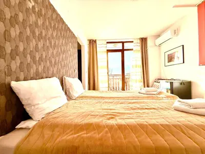a bedroom with a large bed in a room at Family Hotel Carpe Diem in Banya