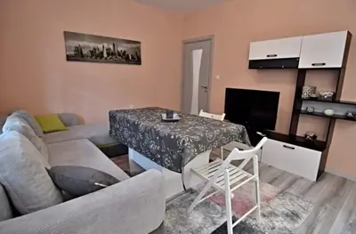a living room with a couch and a table at Апартамент Фреш in Velingrad