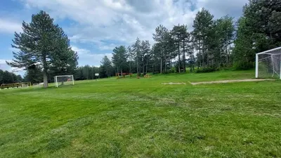 a soccer field with a goal in the grass at Сладко студио в Пирин с голф и СПА комплекс in Razlog