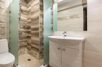 a bathroom with a toilet and a sink and a shower at Апартаменти 22 in Velingrad