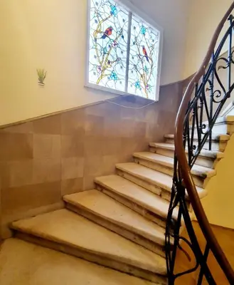 a set of stairs with a stained glass window at Hotello in Sofia