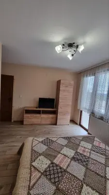 an empty room with a bed and a ceiling fan at Родопска къща за гости с.ЧАЛА in Chala
