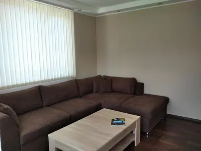 a living room with a couch and a coffee table at Къща за гости Релакс-Рaдуил in Raduil