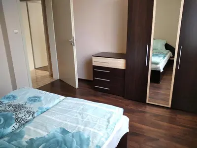 a bedroom with a bed and a dresser and a mirror at Къща за гости Релакс-Рaдуил in Raduil
