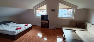 a small bedroom with a bed and a couch at Къща за гости Релакс-Рaдуил in Raduil