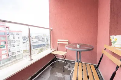 a table and chairs in a room with a window at Lovely apartment in Studentski grad in Sofia