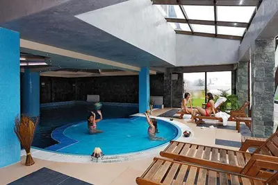 a group of people in a swimming pool at 500м. от лифта Сладък дом в Белведере СПА комплекс in Bansko