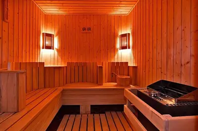 a sauna with a tub and a stove in it at 500м. от лифта Сладък дом в Белведере СПА комплекс in Bansko