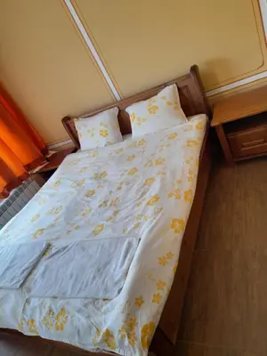 an unmade bed in a bedroom with at Къща Ради in Koprivshtitsa