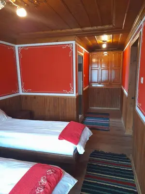 a bedroom with two beds in a boat at Къща Ради in Koprivshtitsa