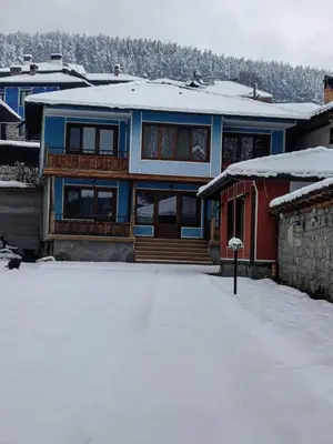 a house with snow on the ground in front of it at Къща Ради in Koprivshtitsa