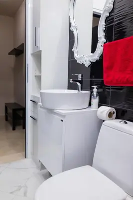 a white bathroom with a sink and a toilet at Harmony Centrally Located Studio in Sofia