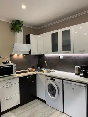 a kitchen with white cabinets and a washing machine at Harmony Centrally Located Studio in Sofia