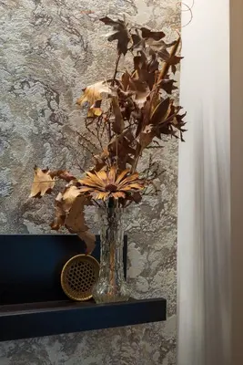 a vase with flowers in it sitting on a shelf at Harmony Centrally Located Studio in Sofia