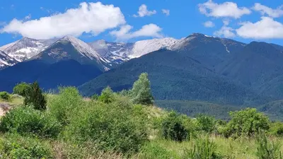 a mountain range with snow capped mountains in the background at Free SPA в Св. Иван Рилски - Сладък дом сред лукс in Bansko