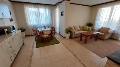 a kitchen and living room with a couch and a table at Free SPA в Св. Иван Рилски - Сладък дом сред лукс in Bansko