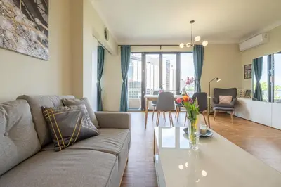 a living room with a couch and a table at Sunrise 1BDRM View Apartment NDK Congress Centre in Sofia