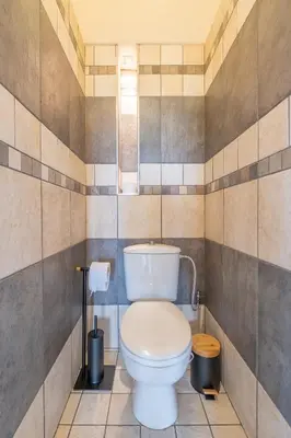 a bathroom with a white toilet in a room at Sunrise 1BDRM View Apartment NDK Congress Centre in Sofia