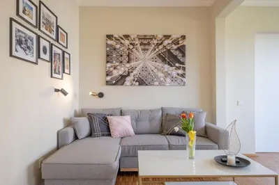 a living room with a couch and a table at Sunrise 1BDRM View Apartment NDK Congress Centre in Sofia