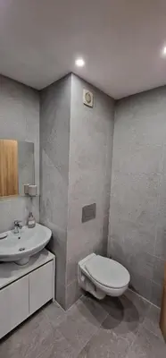 a bathroom with a toilet and a sink at Pine Tree Apartment / Borovets Gardens in Borovets