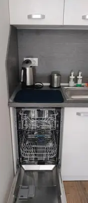 an empty dishwasher in a kitchen next to a sink at Pine Tree Apartment / Borovets Gardens in Borovets