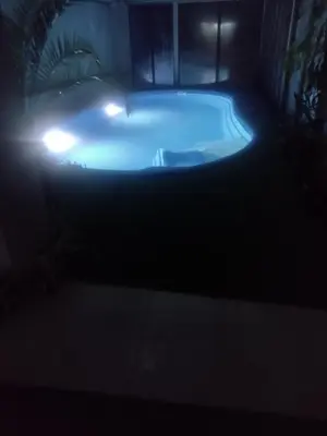 a jacuzzi tub with lights in the dark at Family Hotel Shipkovo in Shipkovo