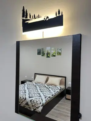 a bedroom with a bed and a shelf on the wall at Georgievi Apartments Sandanski in Sandanski