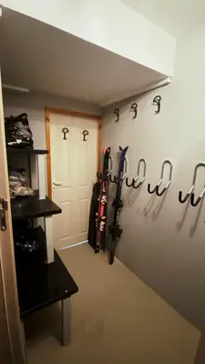a room with skis on the wall next to a door at House Proctor in Stoykite