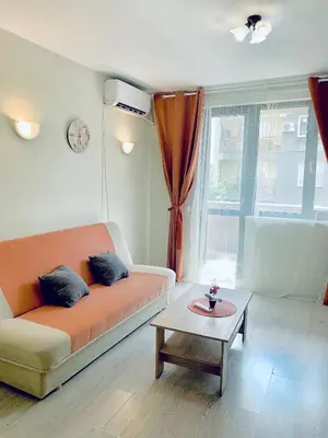a living room with a couch and a coffee table at City Residence Apartments Sofia in Sofia