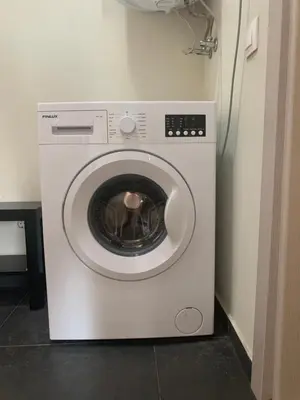 a white washing machine sitting in a room at City Residence Apartments Sofia in Sofia