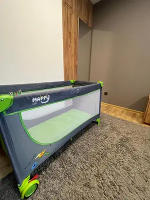 a bed with a tennis in a room at CityApartment in Sofia