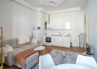 a living room with a couch and a kitchen at Supreme Luxury Top Central 1 Bedroom Apartment in Sofia