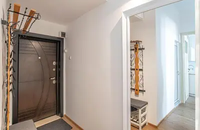 a hallway with a garage door and a mirror at Supreme Luxury Top Central 1 Bedroom Apartment in Sofia