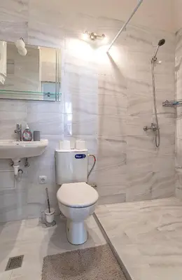 a bathroom with a toilet and a sink and a shower at Supreme Luxury Top Central 1 Bedroom Apartment in Sofia
